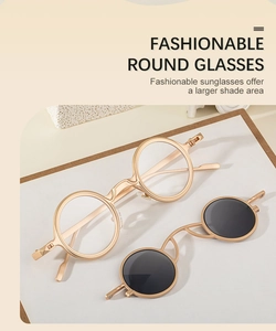 Detail of round metal glasses with removable steampunk clip-on sunglasses lenses