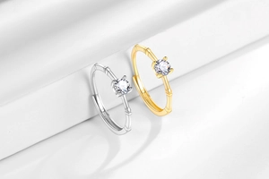 Detail of adjustable bamboo-style rings in silver and gold with sparkling round zircons