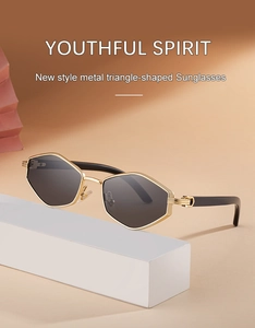 Detailed shot of golden metal geometric sunglasses with dark grey lenses and anti-slip texture