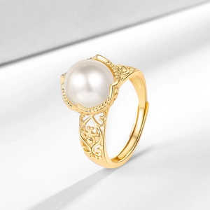 Vintage hollow carved gold open ring featuring a round white faux pearl center
