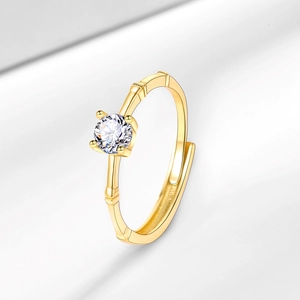 Elegant gold bamboo-style open ring with sparkling round moissanite in 4-prong setting