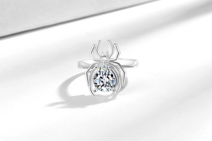 Detail shot of spider ring with a large pear-cut center stone and eight crafted legs