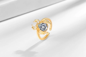 Close-up of golden spider ring featuring a large pear-shaped clear zircon stone