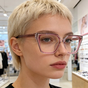 Detail of trendy cat-eye glasses frame in transparent pink and purple on female model