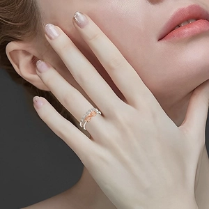 Silver and rose gold infinity ring with pave crystals worn on woman finger