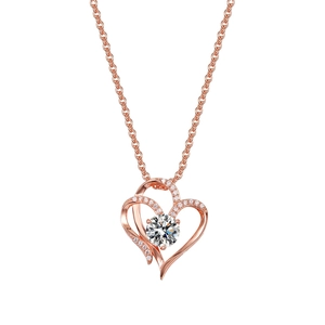 Detail of rose gold double heart necklace with pavé diamonds and a sparkling center stone