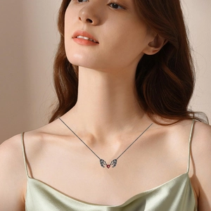 Detail of Gothic necklace featuring a skeleton hand holding a dark red heart pendant