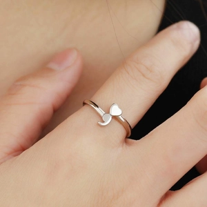 Polished silver semicolon ring featuring a heart and comma symbol in an open design