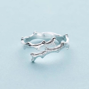 Nature-inspired silver tree branch ring with wood grain texture and adjustable open design