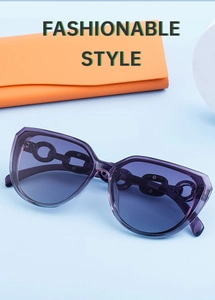 Detail view of purple cat eye sunglasses with gold chain temples on orange pouch