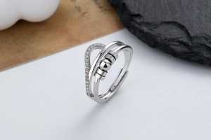 Close-up of a double-layered spinning ring with cubic zirconia and movable metal beads