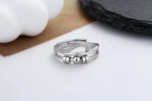 Detail of silver spinning ring with wave micro-pave stones and three movable beads