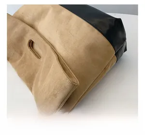 Detail showing the fine stitching on suede and black leather patchwork tote bag