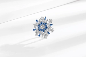 Macro shot of luxury rotating snowflake ring with inlaid blue and white zircons