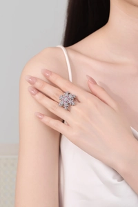 Close-up of rotating snowflake ring featuring pink crystals and silver-tone finish