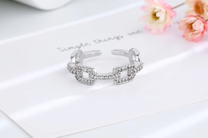 Close-up of chain link ring in silver with sparkling cubic zirconia pavé stones