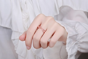 Close-up of elegant rose gold chain ring with sparkling cubic zirconia on model hand