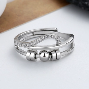 Rotating stainless steel spinner ring with wavy zircon band and movable center beads