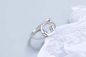 Close-up of rotatable silver beads and geometric open ring with minimalist textures