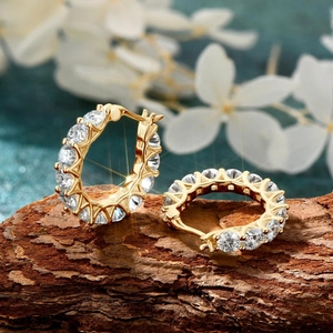Detail view of gold S925 silver hoop earrings featuring 3.80ct cubic zirconia stones