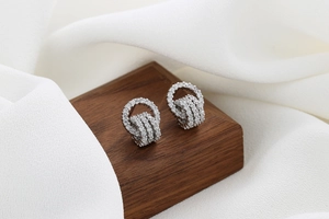 Detailed macro view of silver hoop earrings with shimmering white cubic zirconia pave setting