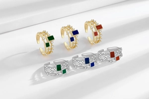 Macro detail of triple-layered enamel rings with sparkling zircon inlay and geometric design