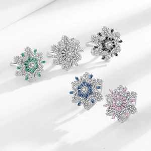 Rotating snowflake rings in five colors featuring crystals and a silver polished base
