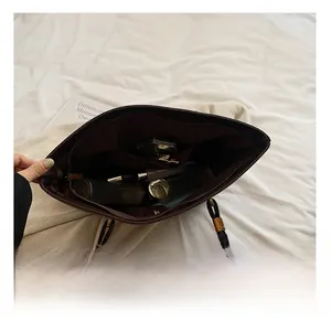 Top view of spacious interior in deep brown tote bag with zipper pocket and essentials