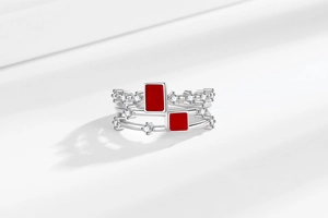 Macro shot of silver ring with red enamel rectangles and fine cubic zirconia accents