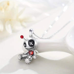 Gothic voodoo doll necklace in 925 silver with red heart gem and black stitching