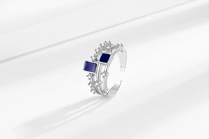 Detail view of silver layered ring featuring blue square enamel and sparkling zircon accents