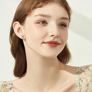 Gothic silver panda stud earrings for women shown as worn on a model in a close-up view