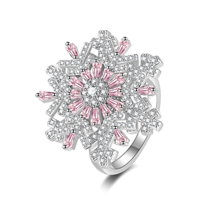 Luxury rotating snowflake ring with pink baguette stones and white cubic zirconia