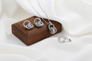 Sparkling zircon jewelry set detail including tiered necklace, earrings, and open ring