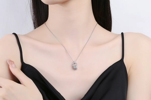 Close-up of sparkling zircon nested circles necklace worn by an elegant model