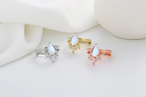 Three-piece crown ring set in silver, gold, and rose gold with pear-cut opals and zircon