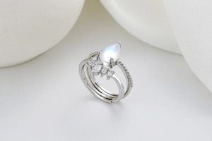 Detail of silver crown ring featuring a pear-cut moonstone and marquise zircons