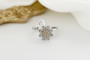 Macro detail of rotating sunflower ring with layered petals and golden center accents