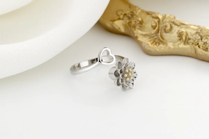 Detailed close-up of layered lotus flower ring with golden center and heart pattern