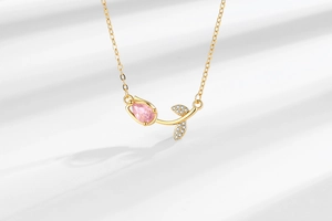 Detailed view of tulip pendant with pink pear-shaped stone and crystal leaves