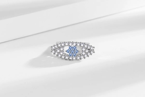 Macro view of flower shaped zircon ring with light blue center stones and silver finish