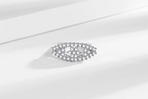 Macro detail of silver ring featuring hollow design and sparkling pave zircon crystals