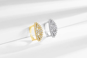 Detailed shot of gold and silver plated adjustable rings with pave set zircon stones
