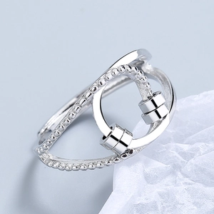 Modern spinning bead ring for anxiety relief on a minimalist textured background