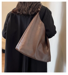 Detailed view of dark brown minimalist tote bag in soft leather with large capacity