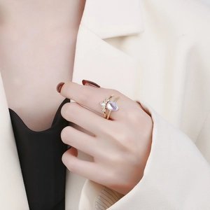 Elegant gold-plated crown ring with light blue gemstone and marquise zircons worn on finger