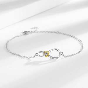 Elegant infinity and golden heart pendant necklace with shimmering crystals on silver chain