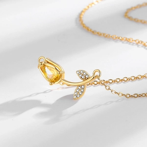 Elegant gold tulip pendant necklace with yellow teardrop gemstone and sparkling accents