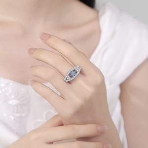 Elegant silver wedding ring with star-shaped blue gemstone and micro-pave zircon crystals