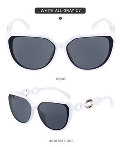 Detailed front and side view of white cat-eye sunglasses with gold chain link temples